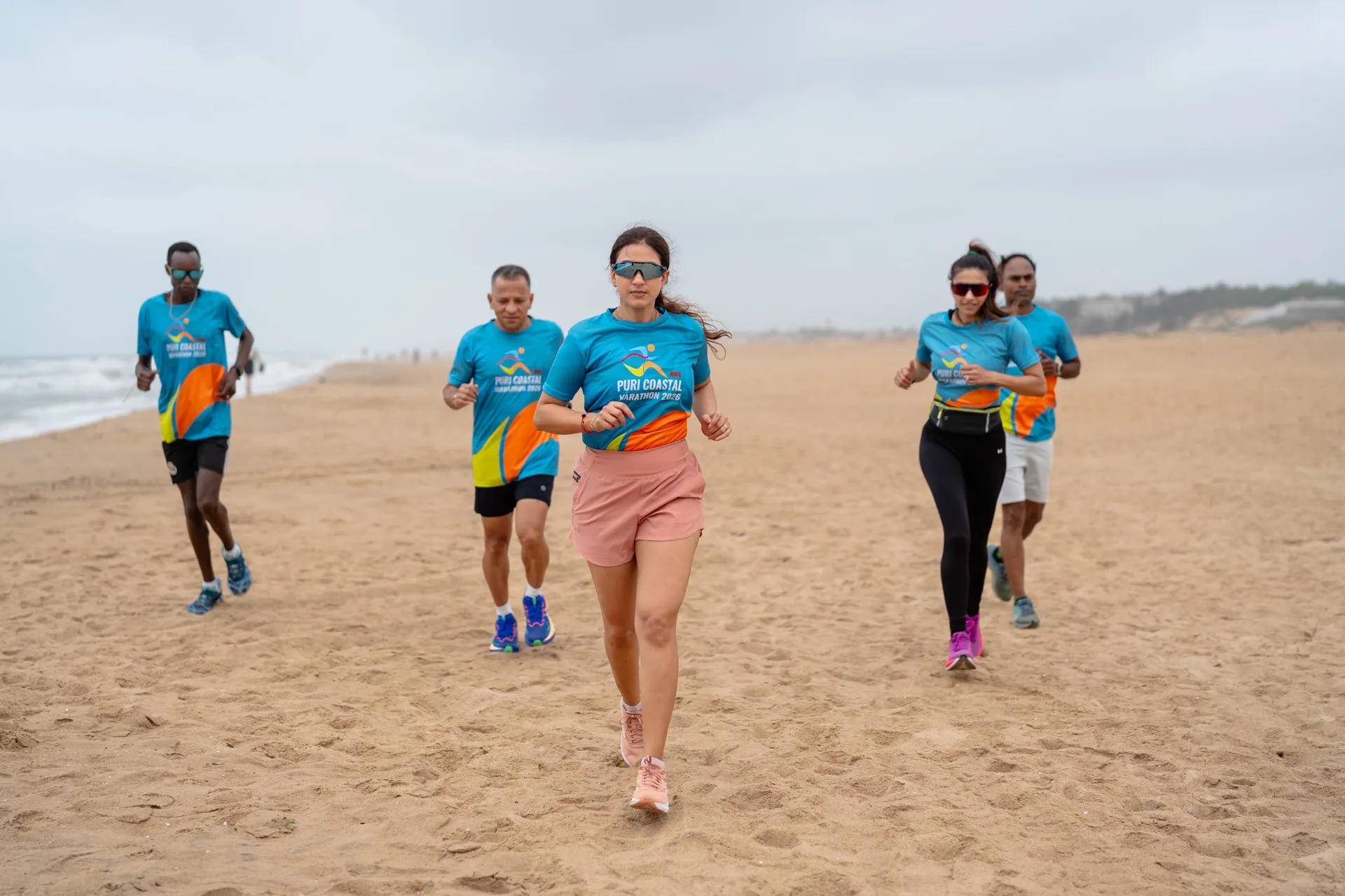 PCM 2025 — runners on Blue Flag Beach